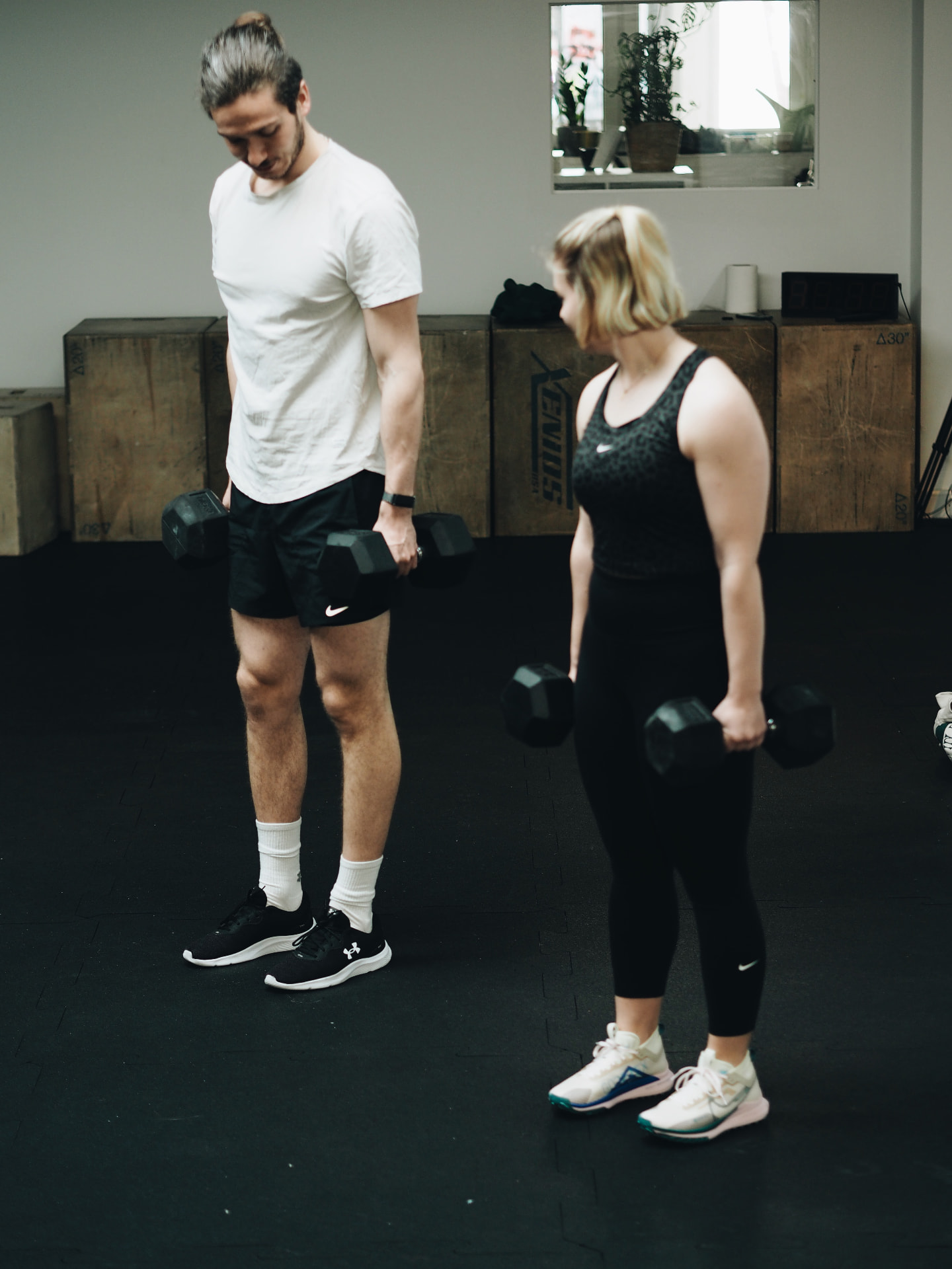 Two athletes with dumbbells on the Studio 58 training floor