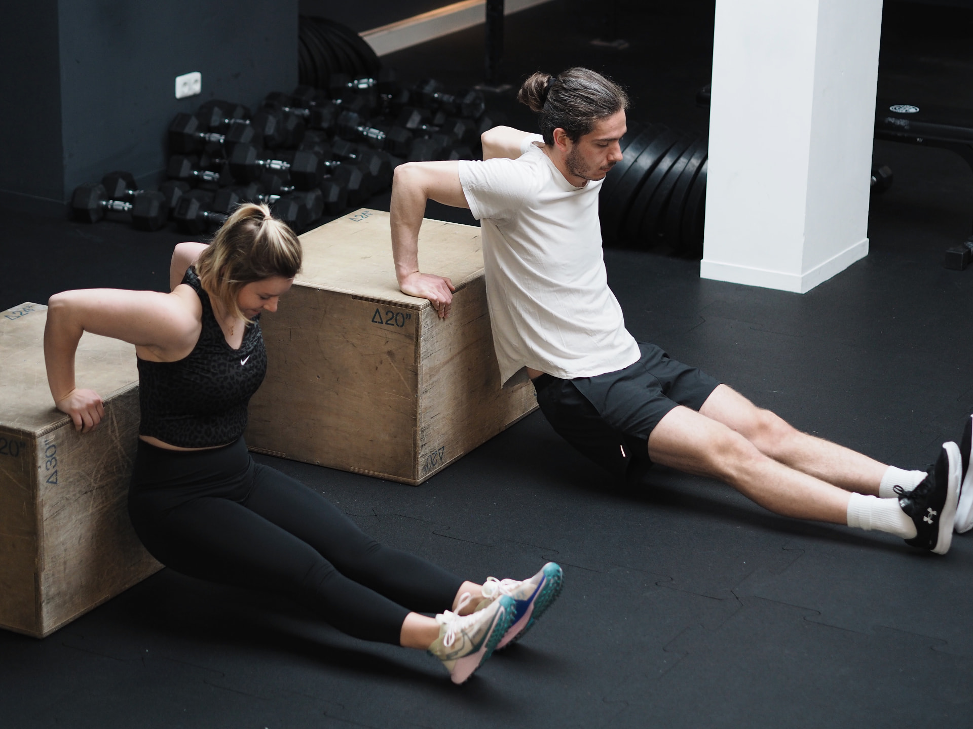 Two athletes doing box dips during a small-group session at Studio 58